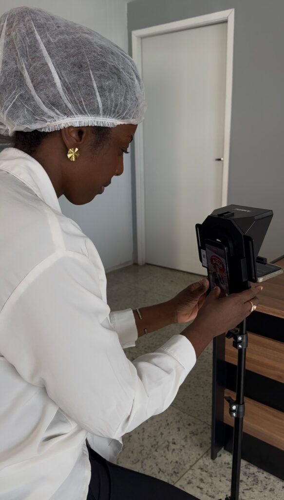 Caroline Justino preparando o teleprompter para uma captação de conteúdo